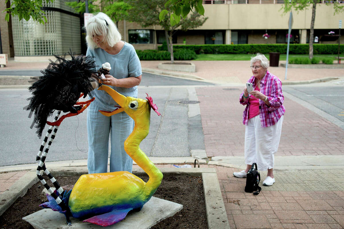 BRITTNEY LOHMILLER | blohmiller@mdn.net Alice Strack, right, watches as Sally Allan, left, puts the finishing touches on their sculpture 'Prickly Pair' on Wednesday morning in downtown Midland.