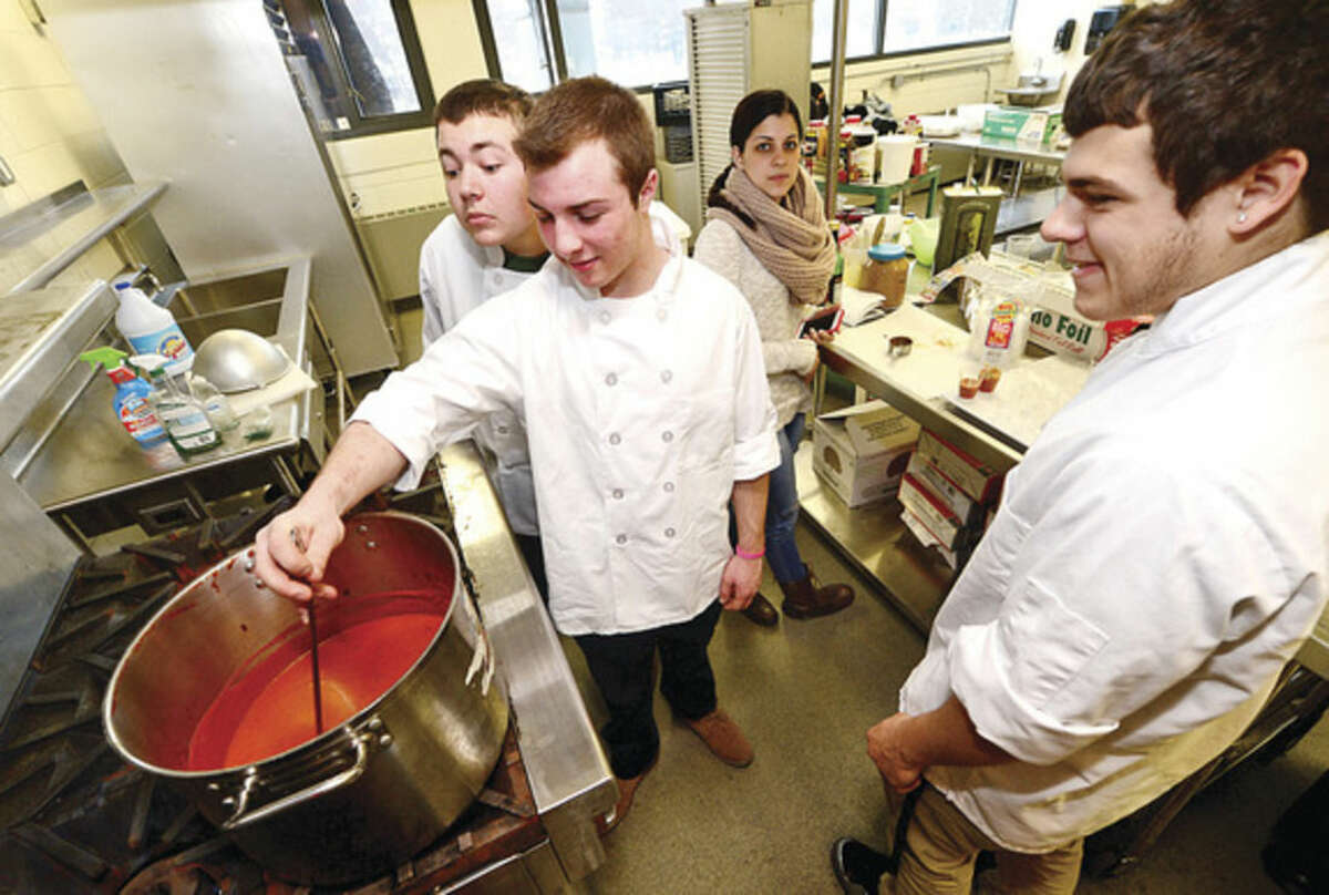 Hour photo / Erik Trautmann Norwalk High School students Scott Castorina, Zach Grimm and Cody Mastropietro cook for the grand opening and ribbon cutting ceremony of the new Culinary Arts Café. The café will be a "learning center" providing real world experiences and hands on activities for the students of Norwalk High.