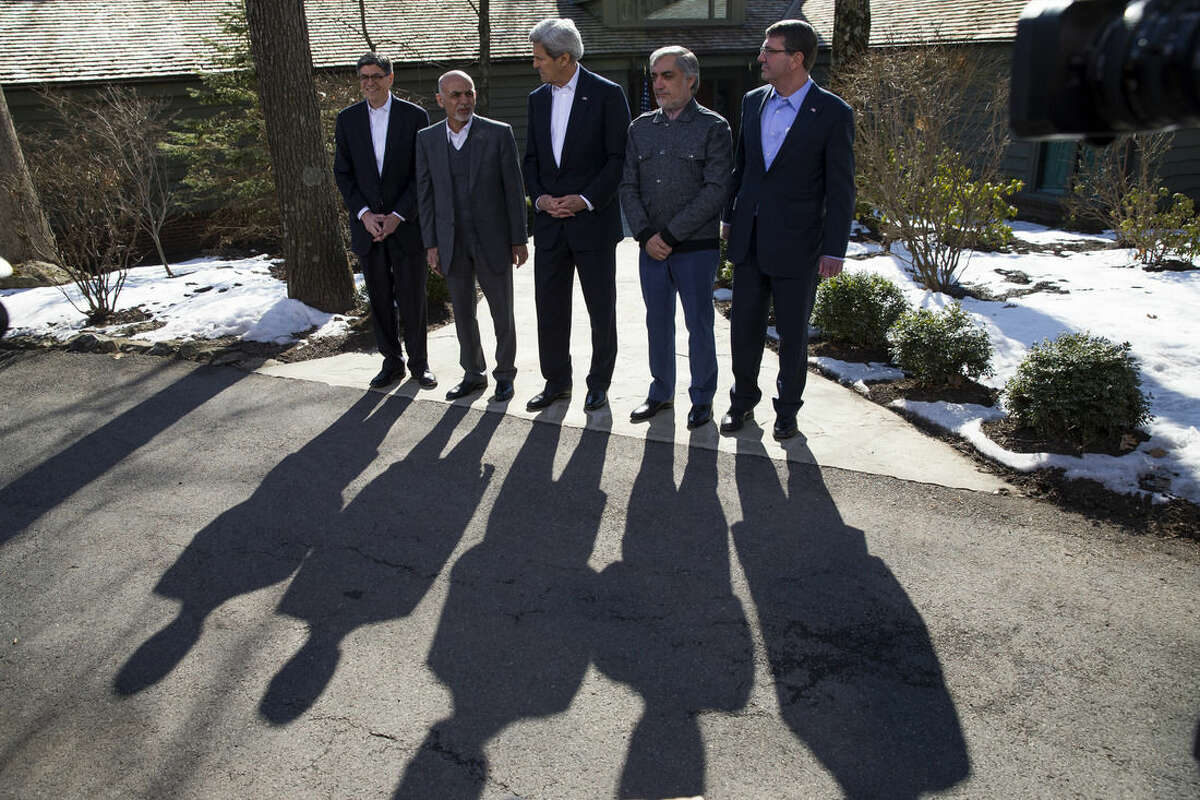 Secretary of State John Kerry, center, speaks before the start of meetings at the Camp David Presidential retreat, Monday, March 23, 2015, in Camp David, Md. The pace of U.S. troop withdrawals from Afghanistan will headline Afghan President Ashraf Ghani's visit to Washington, yet America's exit from the war remains tightly hinged to the abilities of the Afghan forces that face a tough fight against insurgents this spring. From left are, Treasury Secretary Jacob Lew, Afghanistan's President Ashraf Ghani, Kerry, Afghanistan's Chief Executive Abdullah Abdullah, and Defense Secretary Ash Carter. (AP Photo/ Evan Vucci)