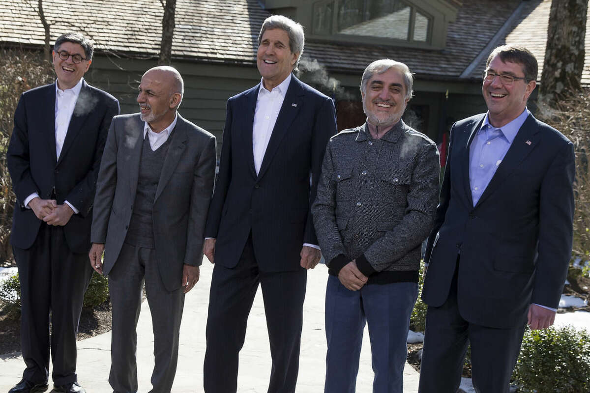 Secretary of State John Kerry, center, shares a laugh with from left, Treasury Secretary Jacob Lew, Afghanistan's President Ashraf Ghani, Kerry, Afghanistan's Chief Executive Abdullah Abdullah, and Defense Secretary Ash Carter after speaking before the start of meeting at the Camp David Presidential retreat, Monday, March 23, 2015, in Camp David, Md. The pace of U.S. troop withdrawals from Afghanistan will headline Afghan President Ashraf Ghani's visit to Washington, yet America's exit from the war remains tightly hinged to the abilities of the Afghan forces that face a tough fight against insurgents this spring. (AP Photo/ Evan Vucci)