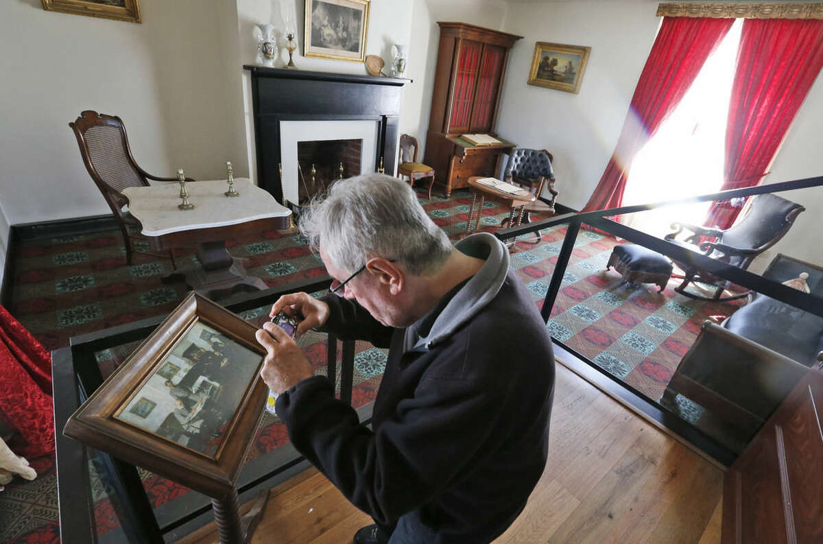 A visitor photographs a depiction of the surrender of the Confederate army in the parlor of the reconstructed McLean house at the Appomattox Court House National Historical Park in Appomattox, Va., Joshua Malatino and Amanda Scott. Confederate General Robert E. Lee surrendered his approximately 28,000 troops to Union General Ulysses S. Grant in the front parlor of Wilmer McLean’s home in Appomattox Court House, Virginia, effectively ending the American Civil War. (AP Photo/Steve Helber)