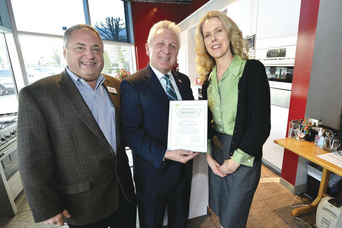 Hour Photo Alex von Kleydorff. Mayor Harry Rilling holds a certificate for the city presented by Live Green Connecticut's Daphne Dixon during a Live Green Connecticut Kick Off with Tony Aitoro at Aitoro's on Westport Avenue.