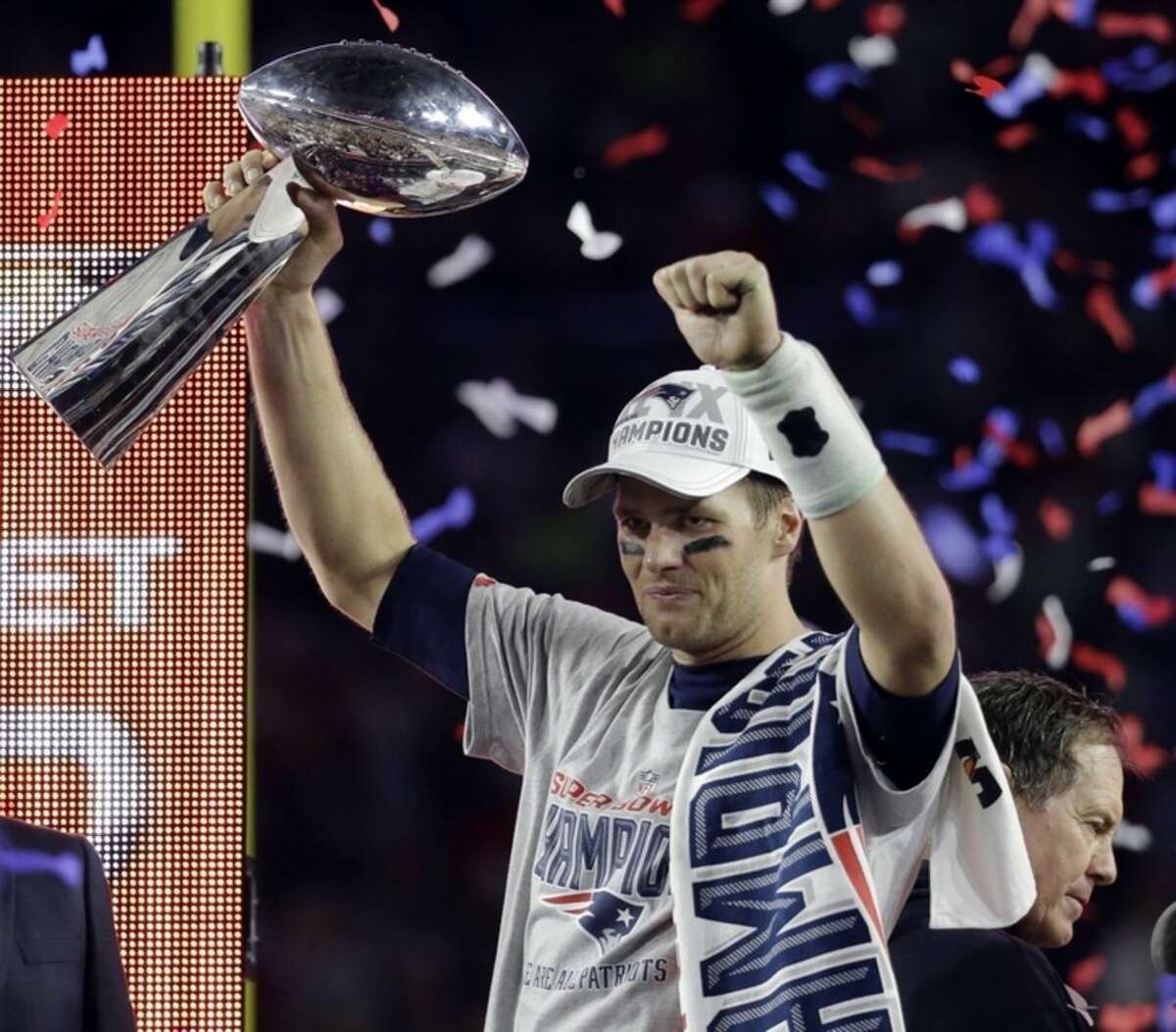FILE - In a Feb. 1, 2015, file photo New England Patriots quarterback Tom Brady holds up the Vince Lombardi Trophy after the Patriots defeated the Seattle Seahawks 28-24 in NFL Super Bowl XLIX in Glendale, Ariz. The NFL Monday, May 11, 2015, suspended Super Bowl MVP Brady for the first four games of the season. (AP Photo/Mark Humphrey)