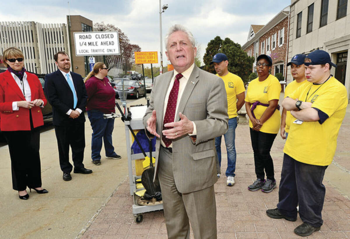 Hour photos/Erik Trautmann Mayor Harry Rilling announces a partnership between Goodwill and the city to keep the Wall Street Business District clean as part of the Mayor's Clean City initiative during a press conference on River Street Tuesday.