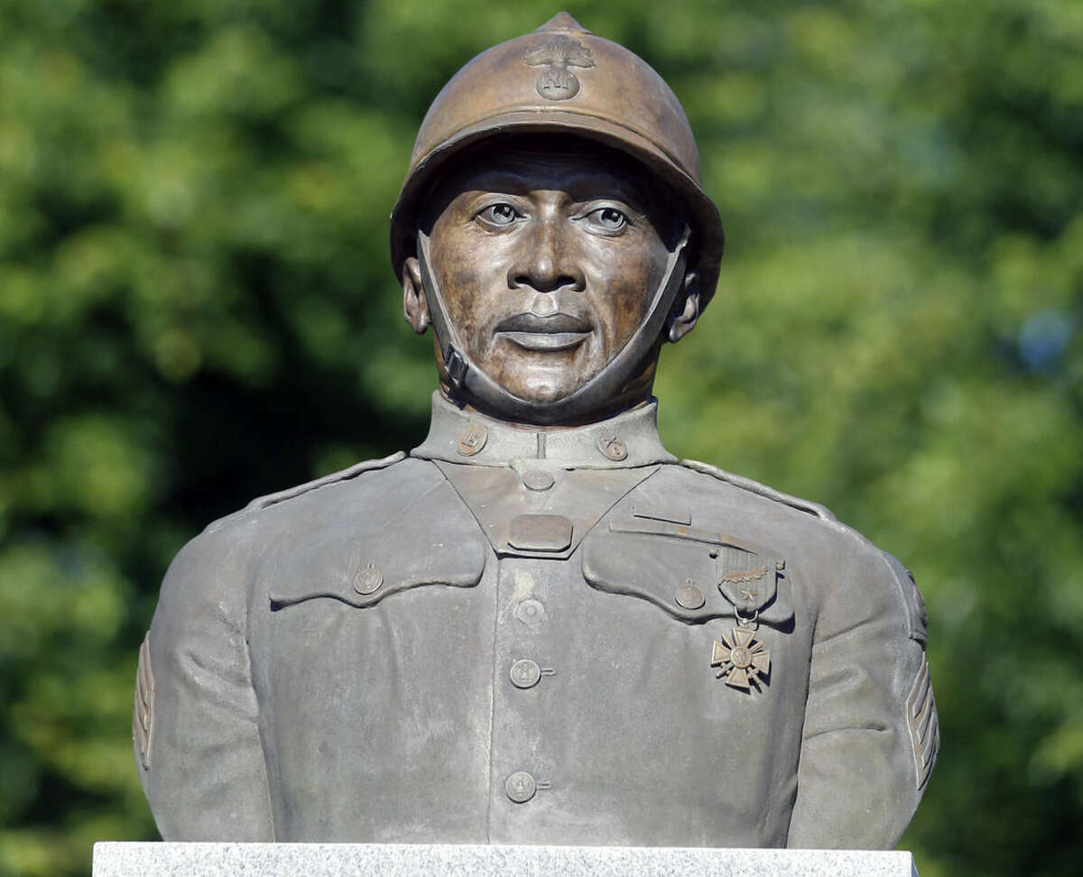 FILE - In this July 10, 2014, file photo, a statue of Henry Johnson is displayed in the Arbor Hill neighborhood in Albany, N.Y. Two World War I Army heroes, Sgt. William Shemin and Johnson are finally getting the Medal of Honor they may have been denied because of discrimination, nearly 100 years after bravely rescuing comrades on the battlefields of France. President Barack Obama plans to posthumously bestow the nation’s highest military honor on both men for their actions in 1918 during a White House ceremony Tuesday, June 2, 2015. (AP Photo/Mike Groll, File)