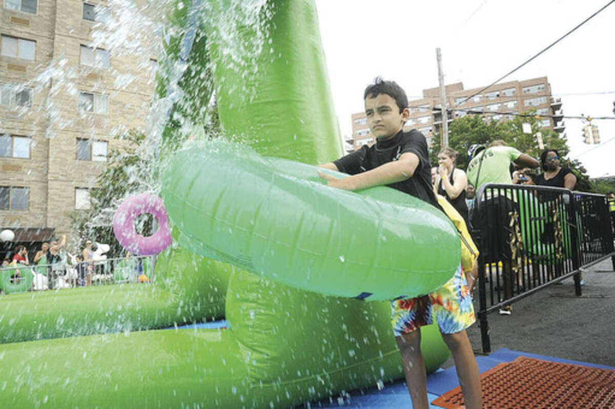Ajay Bagaria 9, gets ready for the ride on the giant water slide at the Slide City event held in downtown Stamford. Hour photo/Matthew Vinci