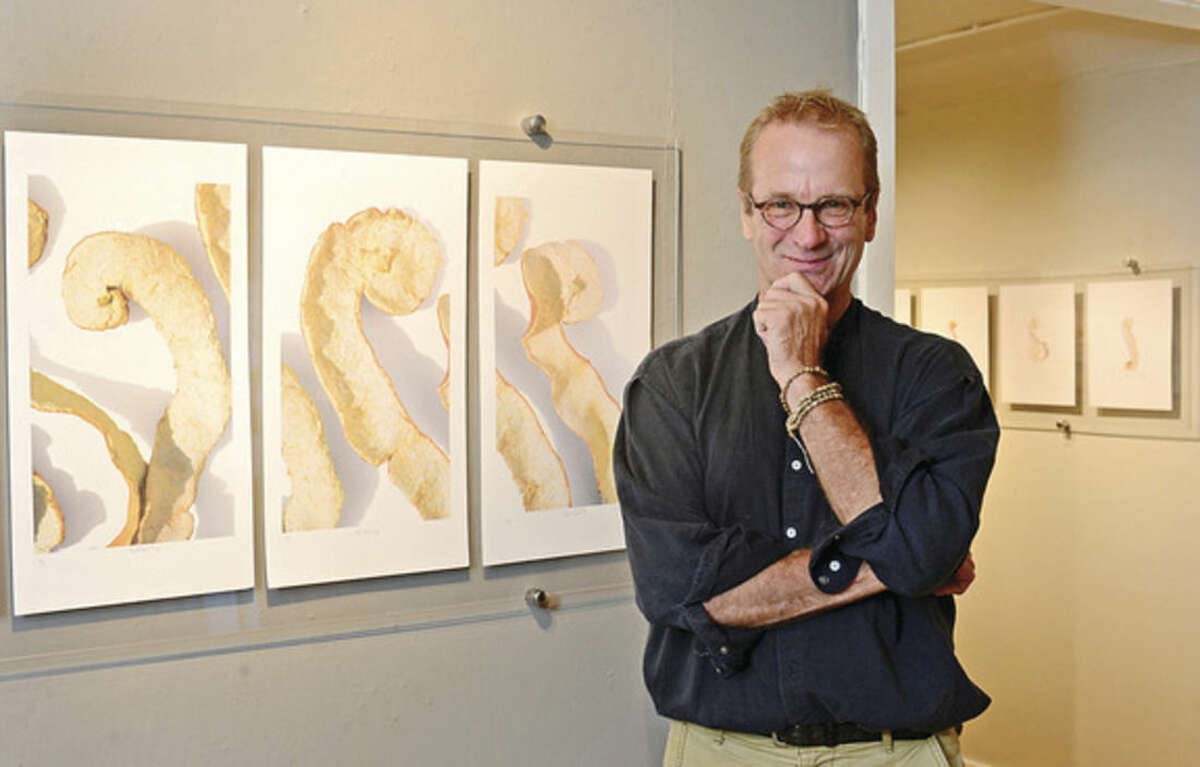 Hour photo / Erik Trautmann Artist and photographer Tom Berntsen with his exhibition at The Silvermine Arts Center, The Peel Project.