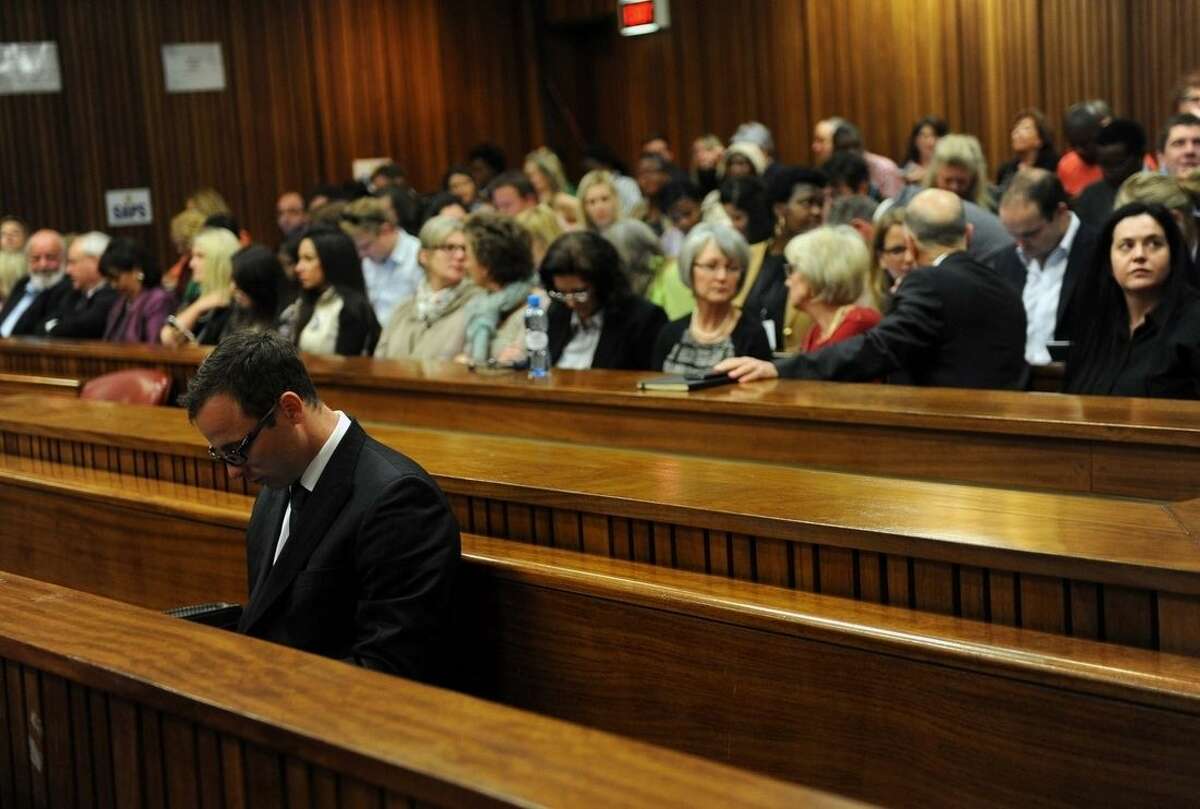 Oscar Pistorius sits in court as his murder trial resumes, in Pretoria, South Africa, Thursday, Aug. 7 2014. The chief prosecutor in Oscar Pistorius' murder trial said Thursday the double-amputee athlete's lawyers have floated more than one theory in a dishonest attempt to defend against a murder charge for his killing of girlfriend Reeva Steenkamp. (AP Photo/Werner Beukes, Pool)
