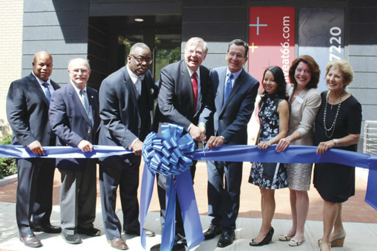 Times photo/Miranda Zhang Stamford Mayor David Martin and Governor Dannel Malloy (center) ceremoneously cut the ribbon at the grand opening of a new downtown apartment complex on Summer Street.