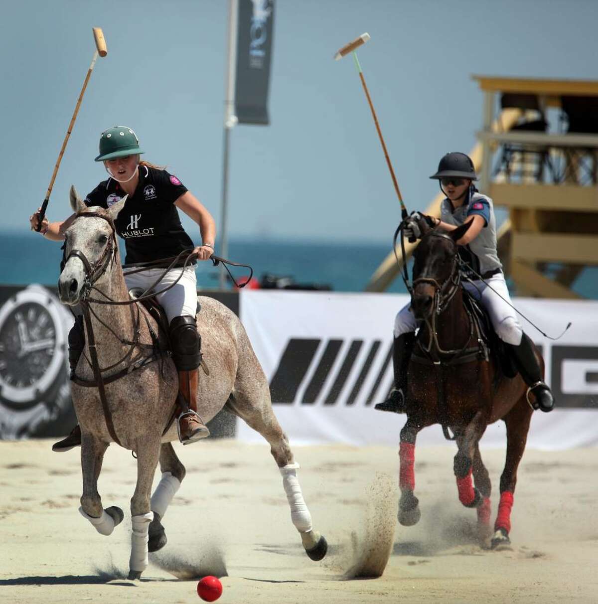 MIAMI BEACH - APRIL 22: Polo players from the Hublot team (L) and Morgan Stanley Smith Barney chase down a ball during their match at the AMG South Beach Women's Polo Cup on April 22, 2010 in Miami Beach, Florida. The women's tournament attracts top players for the beach-side matches. The men's AMG Miami Beach Polo World Cup tournament starts tomorrow and runs through Sunday. (Photo by Joe Raedle/Getty Images)