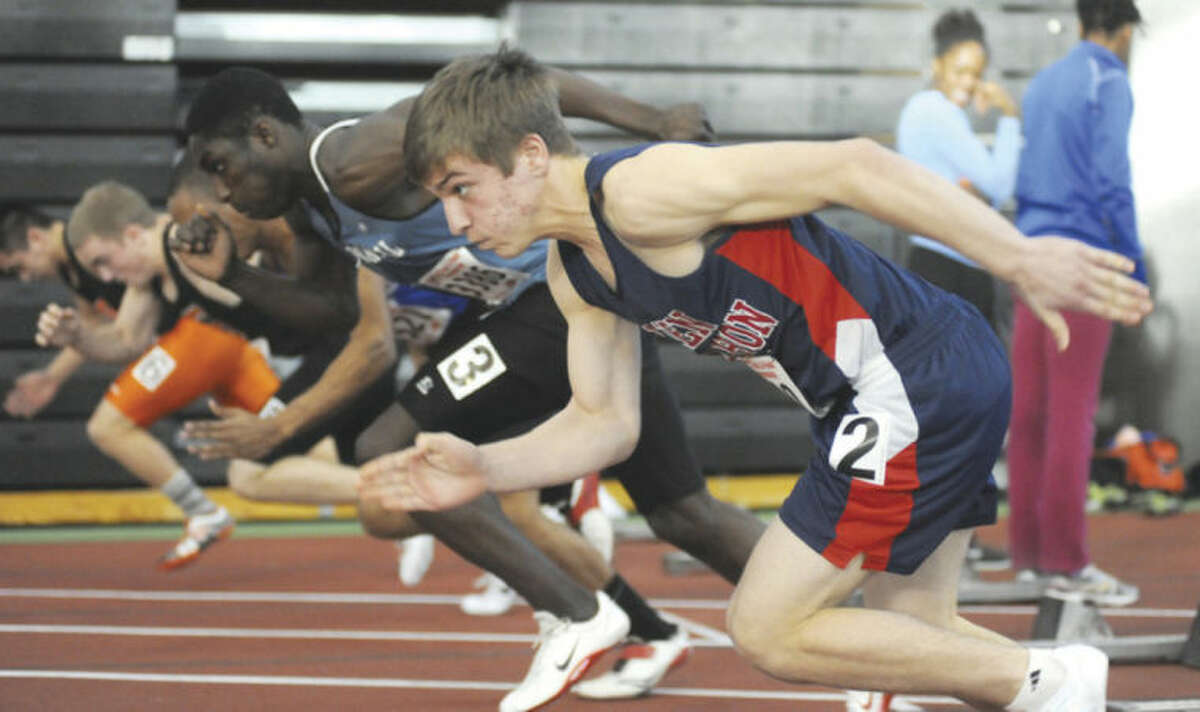 Hour photo/John Nash Niko Petridis of Brien McMahon, foreground, bursts out of the blocks during the 55-meter heat race at Monday's State Open Track Championship meet in New Haven.