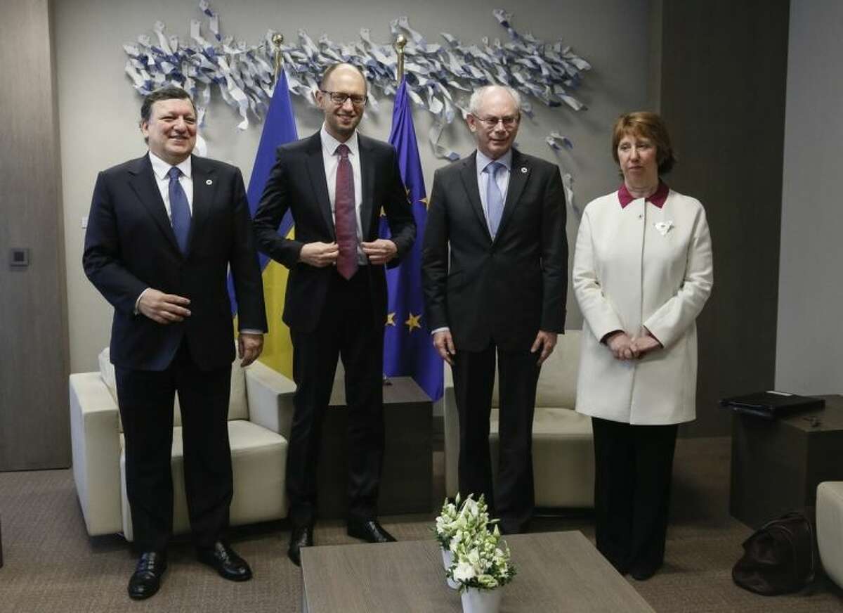 From left, European Commission President Jose Manuel Barroso, Ukraine's Prime Minister Arseniy Yatsenyuk, European Council President Herman Van Rompuy and European Union High Representative Catherine Ashton participate in a meeting during an EU summit in Brussels on Thursday, March 6, 2014. EU heads of state meet Thursday in emergency session to discuss the situation in Ukraine. (AP Photo/Olivier Hoslet, Pool)