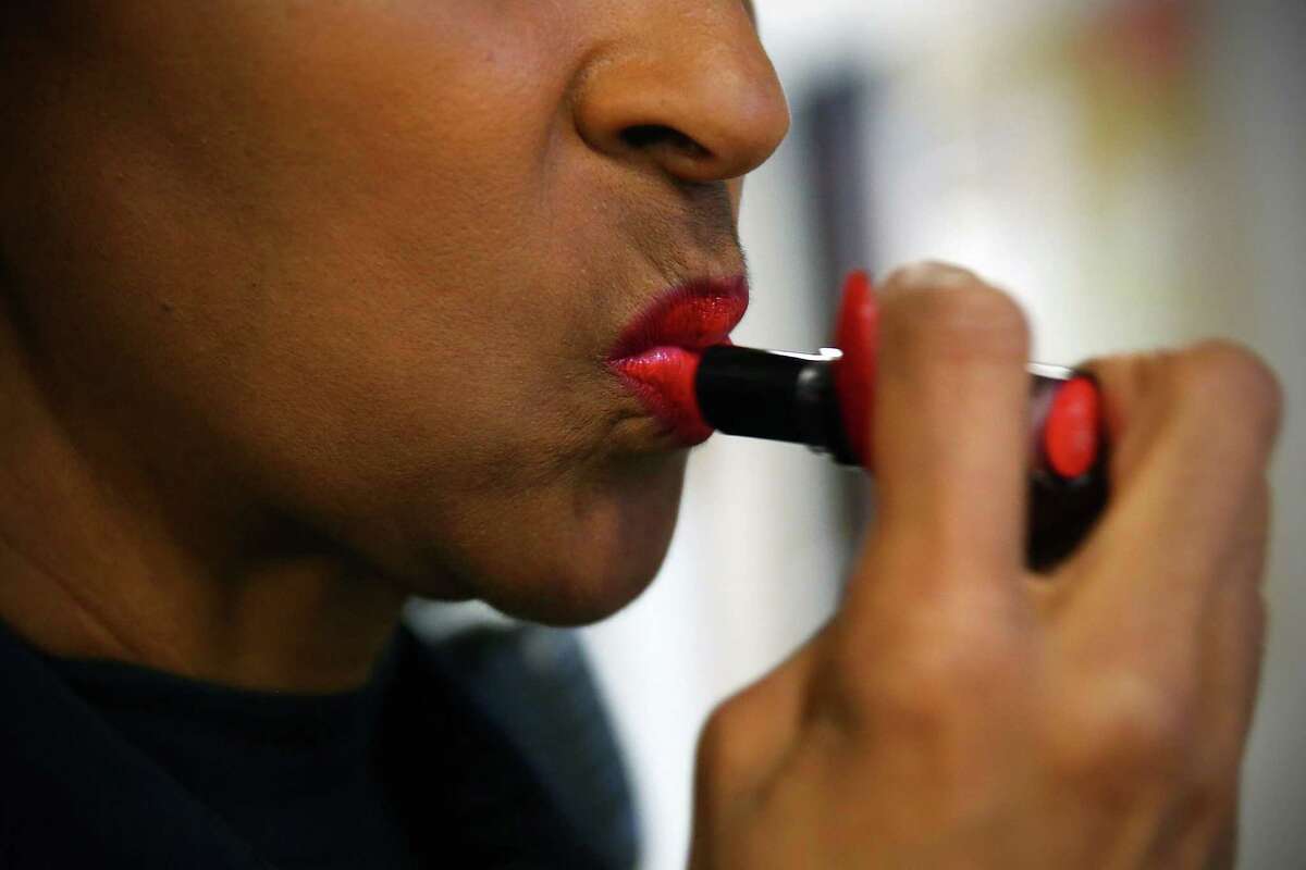 Detective Denise "Cookie" Bouldin reapplies her signature red lipstick, Thursday, June 9, 2016.