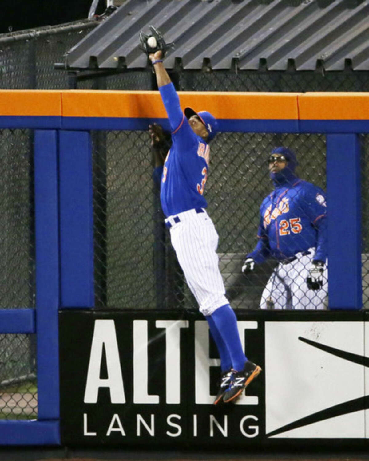 New York Mets' Curtis Granderson catches a ball at the wall hit by Chicago Cubs' Chris Coghlan during the second inning of Game 2 of the National League baseball championship series Sunday, Oct. 18, 2015, in New York. (AP Photo/Frank Franklin II)
