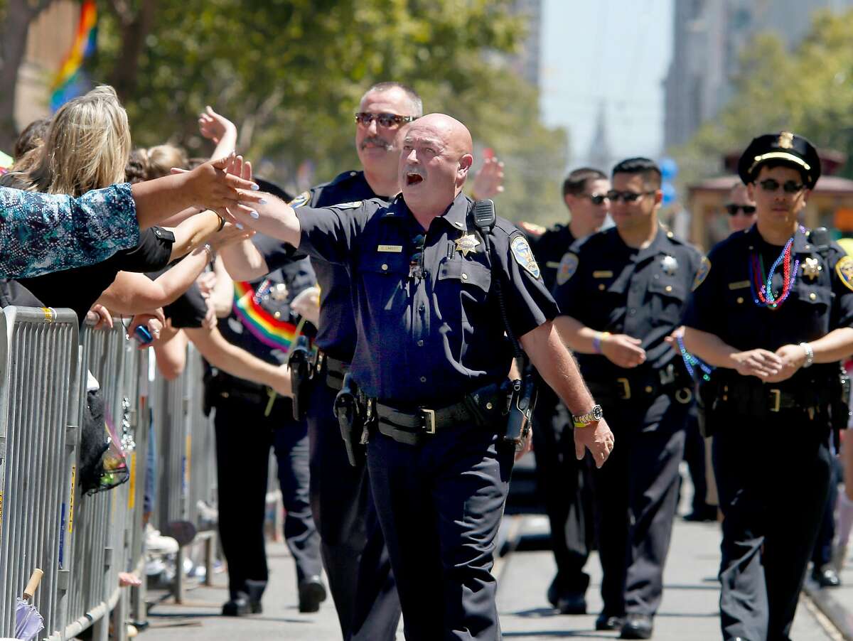 Officer Chuck Lambert greeted the crowd as he marched with the police department. The annual Gay Pride parade on Market Street was held in San Francisco, Calif. Sunday June 29, 2014 and the theme was "Color Our World With Pride."