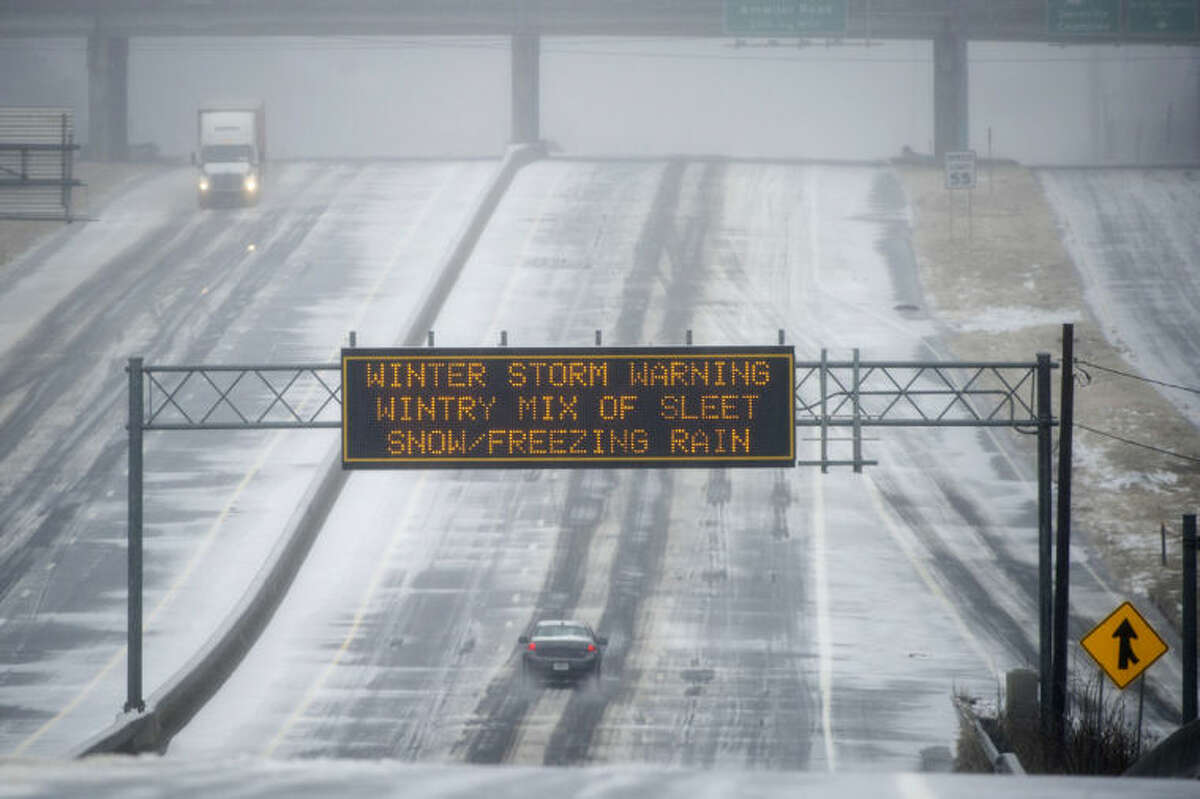 A Georgia DOT sign warns drivers of winter weather as they travel a bleak section of Hwy. 141 on Wednesday, Feb. 12, 2014, in Norcross, Ga. The scene is the opposite of what drivers experienced two weeks ago when every major artery of metropolitan Atlanta was clogged during the last winter storm. (AP Photo/John Amis)