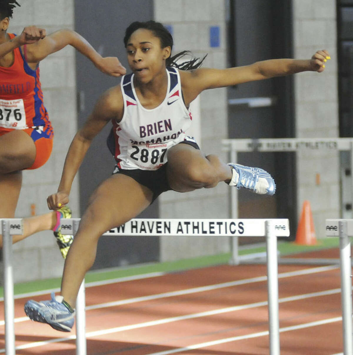Sarah Boyd of Brien McMahon clears a hurdle during her 55-meter hurdles heat race at Monday's State Open Track Championship meet in New Haven. Boyd went on to finish second in the final. Hour photo/ John Nash