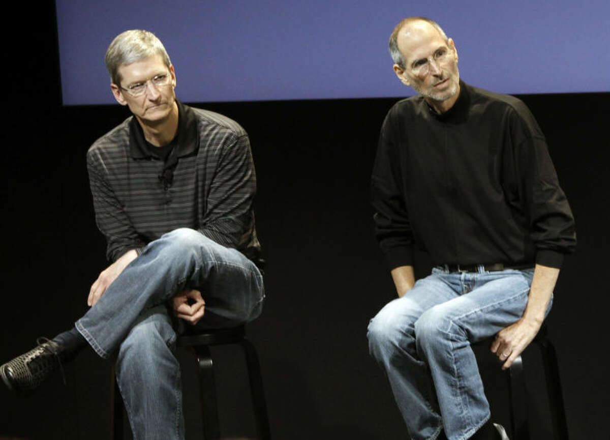 FILE - This July 16, 2010 photo shows Apple's Tim Cook, left, and Steve Jobs, right, during a meeting at Apple in Cupertino, Calif. Apple?’s potential purchase of headphone maker Beats Electronics for $3.2 billion is just the latest example of how much Cook has deviated from Jobs, who had so much confidence in his company?’s innovative powers that he saw little sense in spending a lot of money on acquisitions. (AP Photo/Paul Sakuma, File)