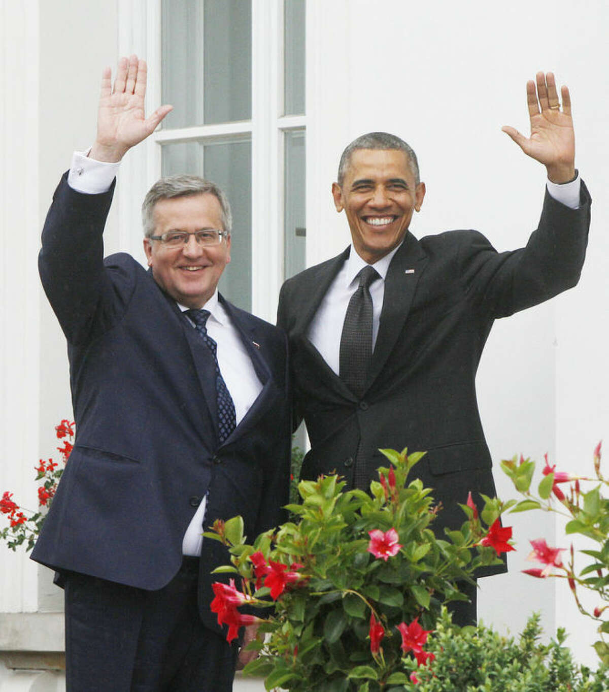 U.S. President Barack Obama,right, and Poland's President Bronislaw Komorowski ,left, wave at Belveder residence in Warsaw, Poland, on Tuesday June 3, 2014.Obama came to Poland to meet regional leaders and attend ceremonies marking 25 years of Poland's democracy. (AP Photo/Czarek Sokolowski)
