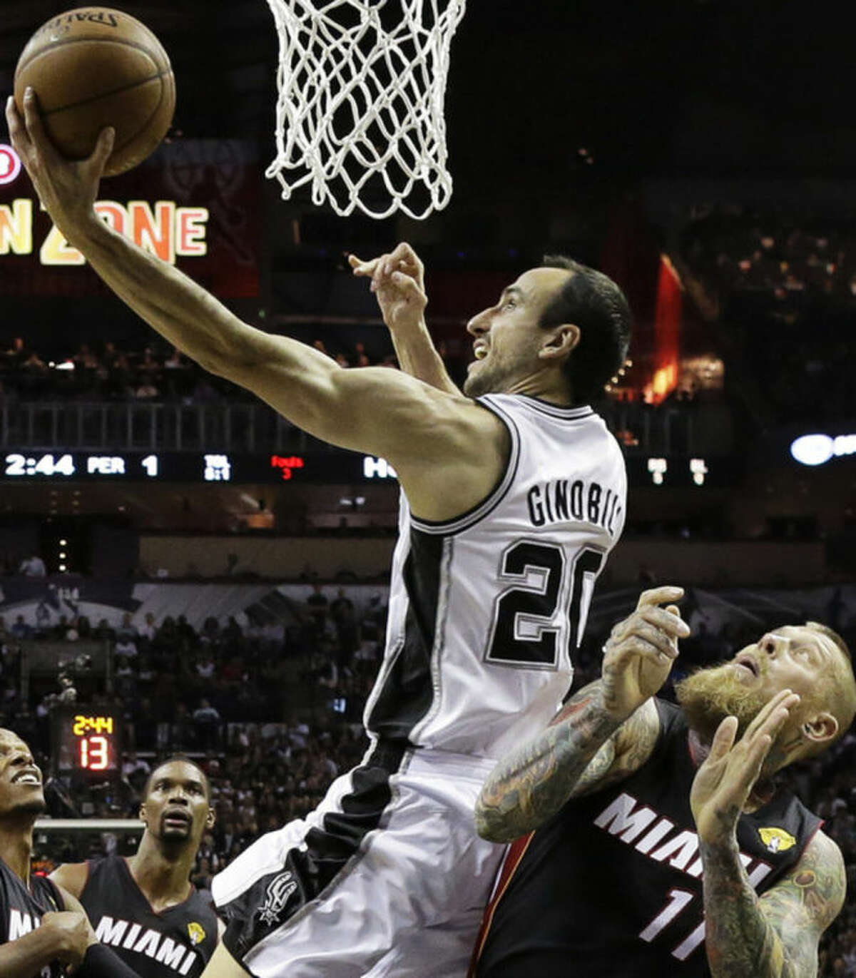 San Antonio Spurs guard Manu Ginobili (20) shoots over Miami Heat forward Chris Andersen during the first half in Game 2 of the NBA basketball finals on Sunday, June 8, 2014, in San Antonio. (AP Photo/Eric Gay)