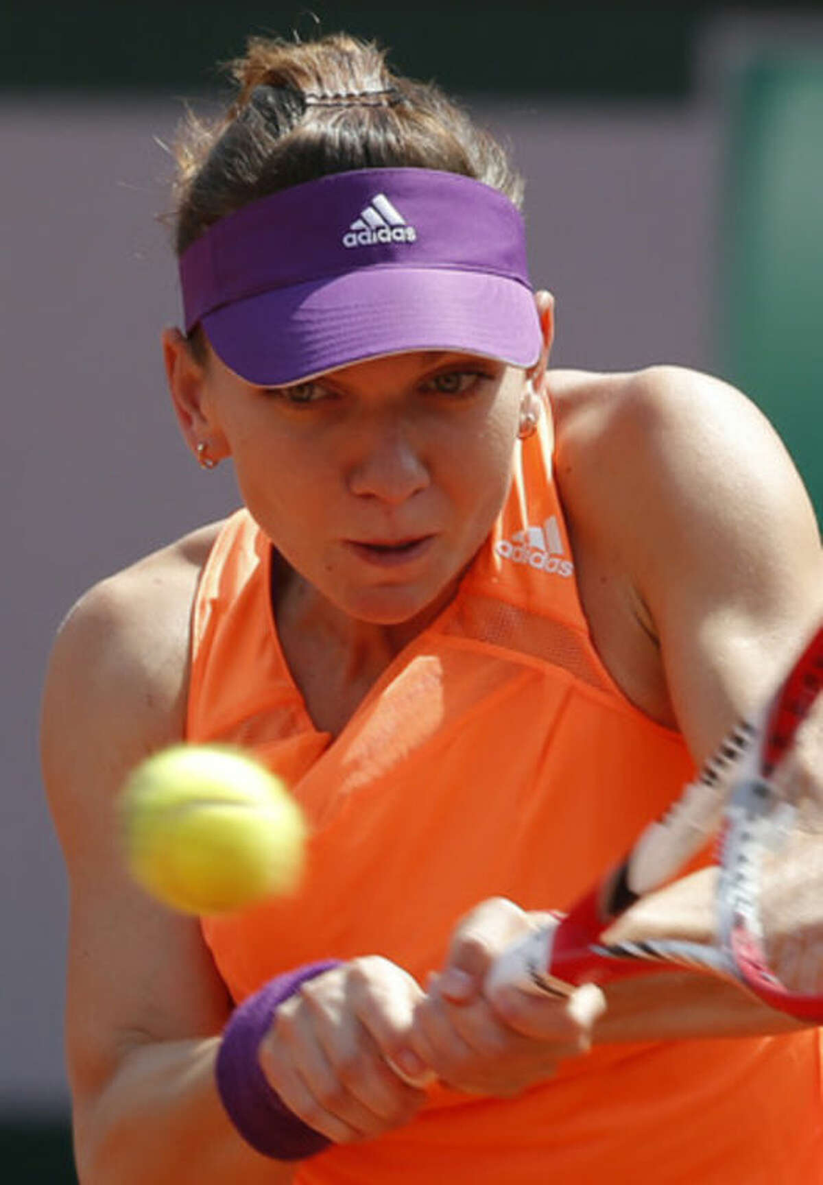 Romania's Simona Halep returns the ball to Russia's Maria Sharapova during their final match of the French Open tennis tournament at the Roland Garros stadium, in Paris, France, Saturday, June 7, 2014. (AP Photo/Michel Euler)