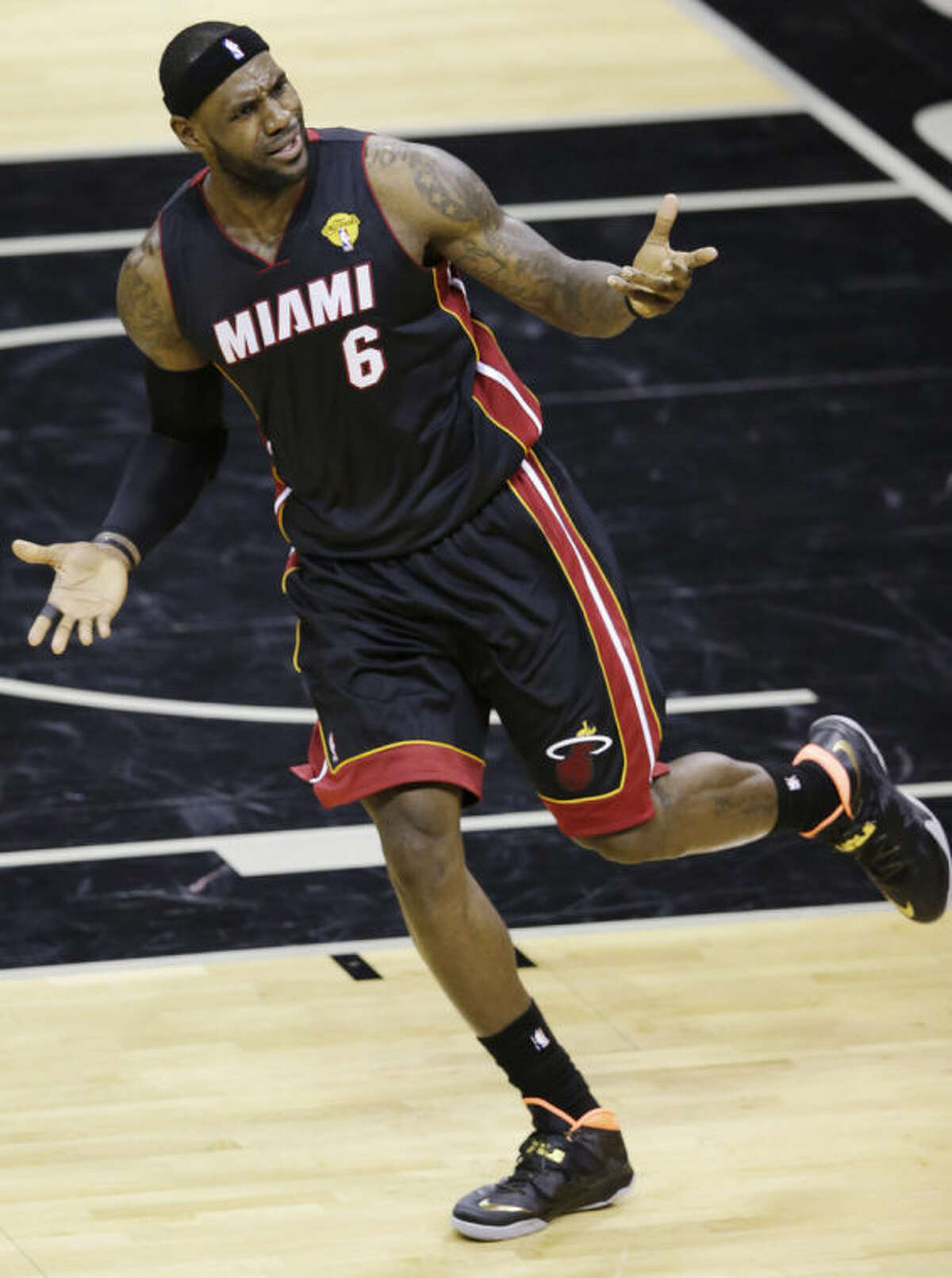 Miami Heat forward LeBron James (6) appeals to an official during the first half in Game 2 of the NBA basketball finals against the San Antonio Spurs on Sunday, June 8, 2014, in San Antonio. (AP Photo/Tony Gutierrez)