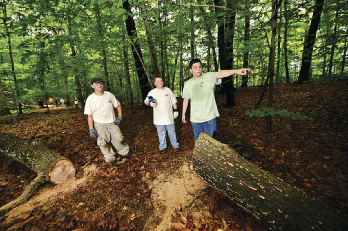 Hour photo / Erik Trautmann Boy Scout Bradley Carrano from Troop 2 directs crews of boy scouts and parents including scouts Tommy Carrano and Michael Mercado who work on improving the hiking trails at Oak Hills Park as part of Carrano's Eagle Scout project.