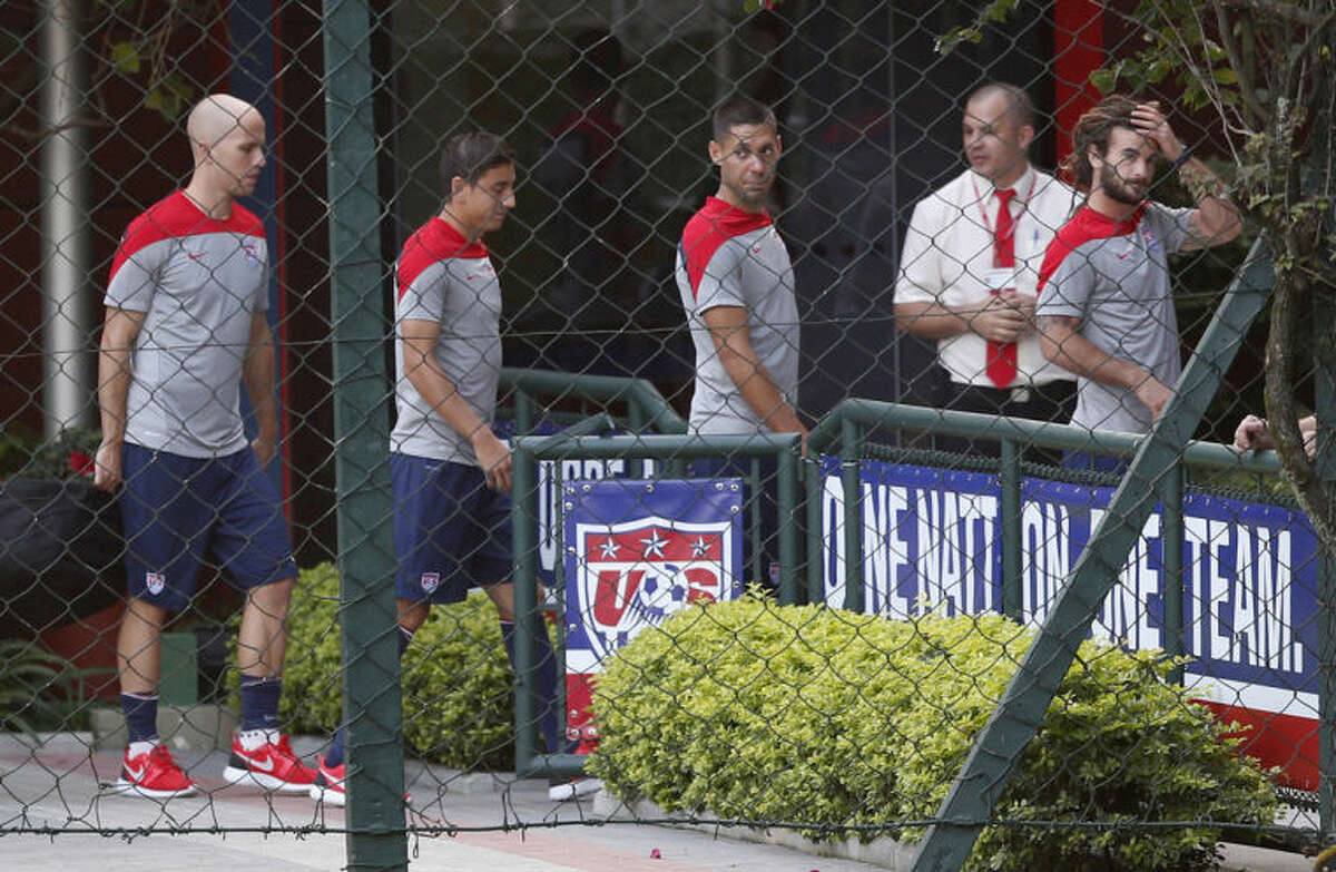 United States' Clint Dempsey, center right, walks with teammates, from left, Michael Bradley, Alejandro Bedoya and Kyle Beckerman to an indoor workout during a training session in Sao Paulo, Brazil, Tuesday, June 17, 2014. The United States will play against Portugal in group G of the 2014 soccer World Cup on June 22. (AP Photo/Julio Cortez)