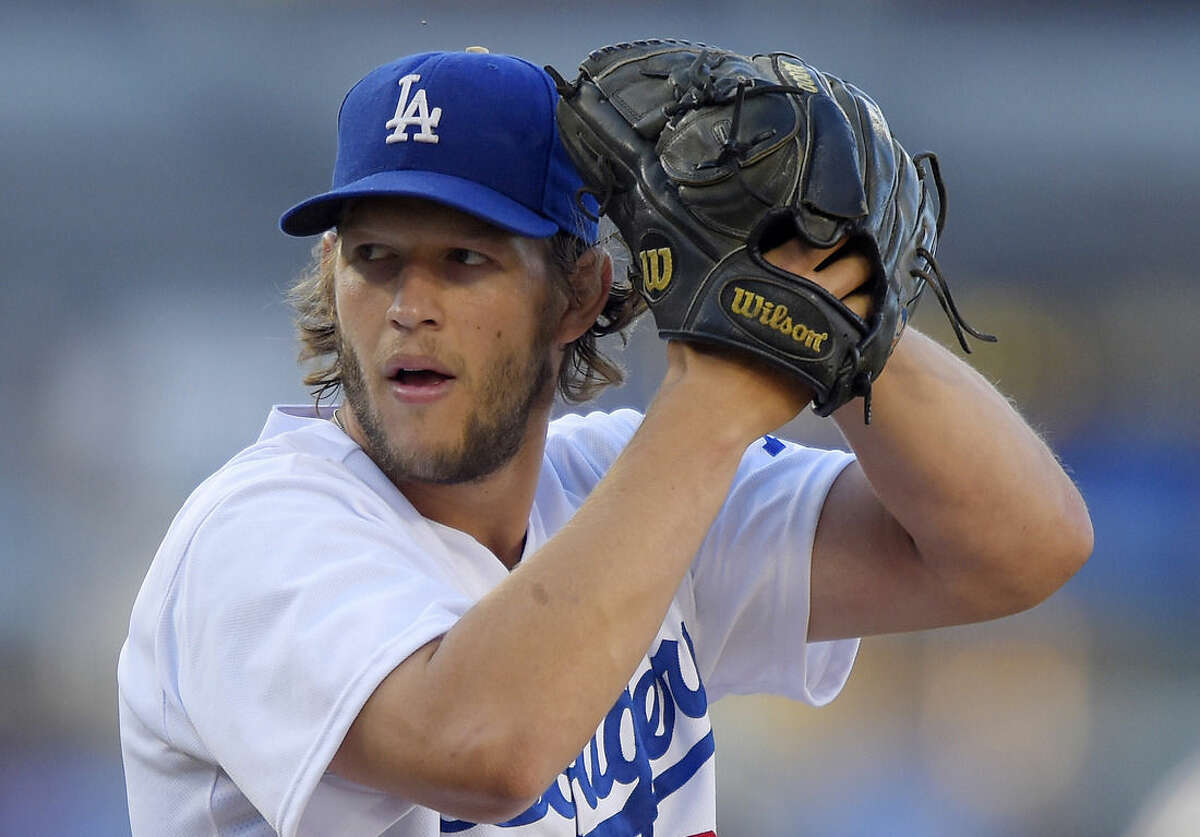 FILE - I this Aug. 16, 2014, file photo, Los Angeles Dodgers pitcher Clayton Kershaw winds up during a baseball game against the Milwaukee Brewers in Los Angeles. Kershaw was named the National League MVP on Thursday, Nov. 13. (AP Photo/Mark J. Terrill, File)
