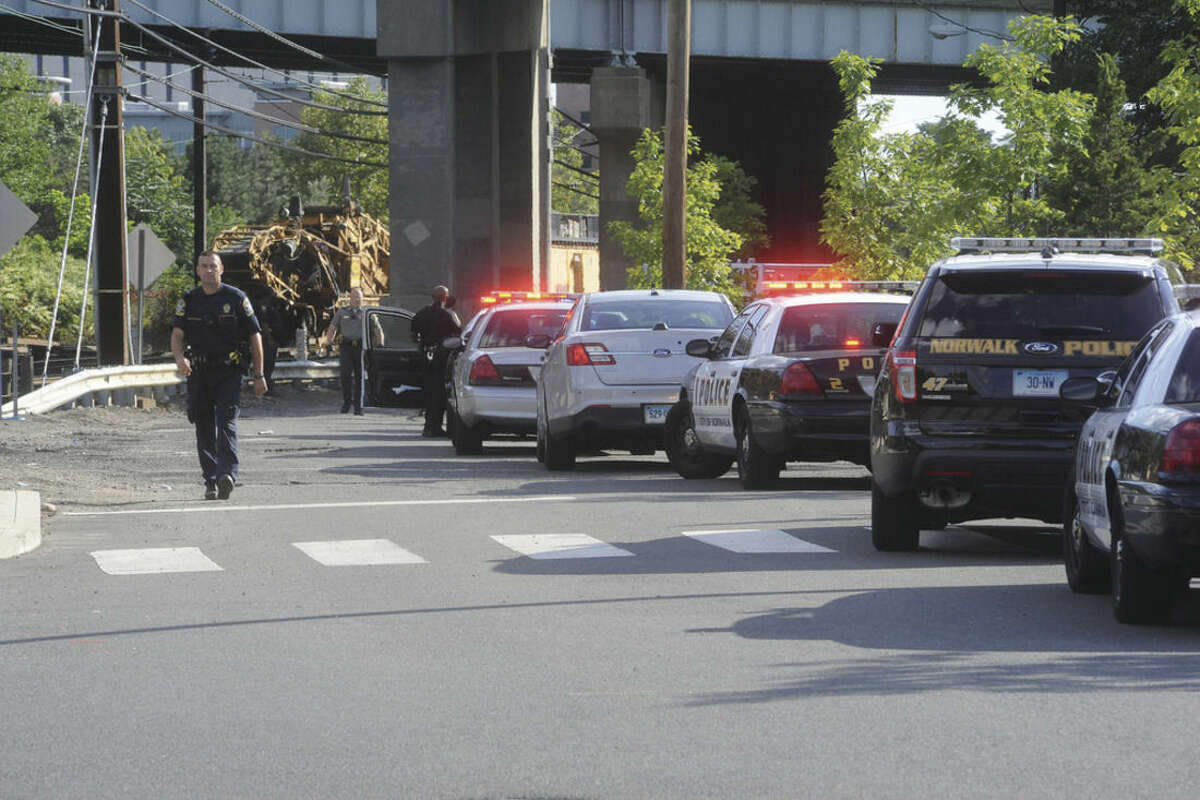 Police respond to the area at Science Street in Norwalk where a fugitive jumped off the bridge at I-95 Monday at around 5:00. Hour photo/Matthew Vinci