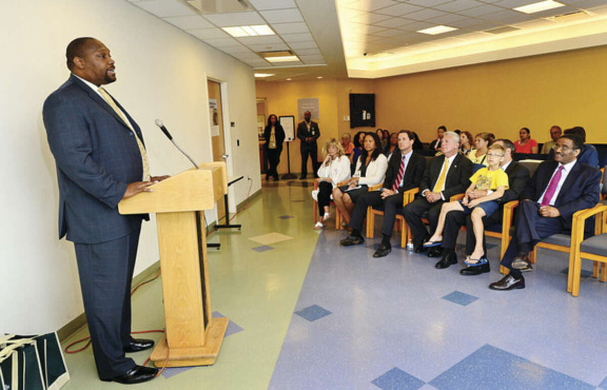 Hour photo/Erik Trautmann Norwalk Community Health Center director Craig Glover addresses dignitaries as the center takes part in a "National Health Center Week" event Wednesday morning.
