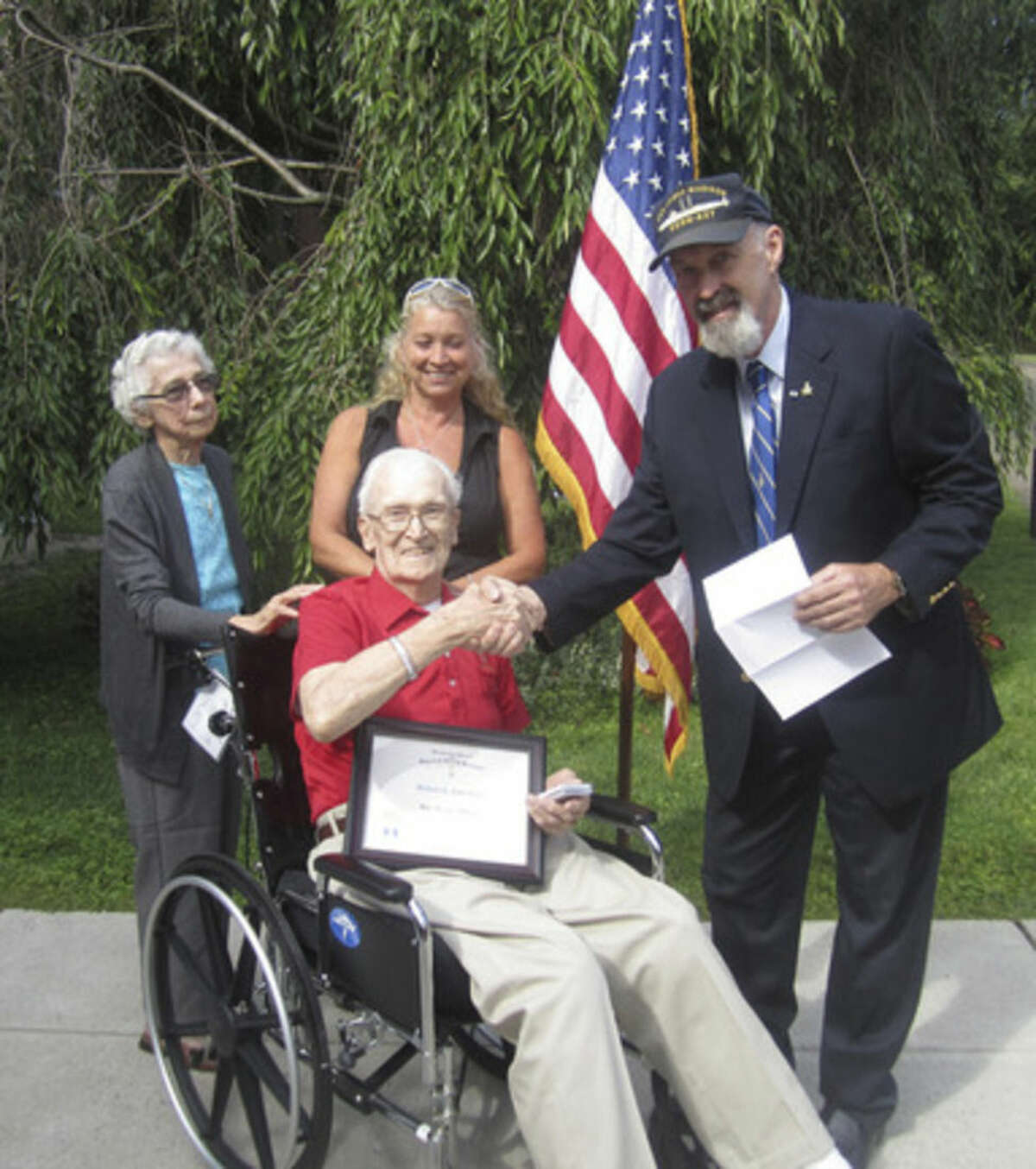 Contributed photo WWII veteran Robert G. Lanehart receives a War Service Medal and Certificate from the Roger Sherman Branch, Sons of the American Revolution this week at Aurora Senior Living in Norwalk.