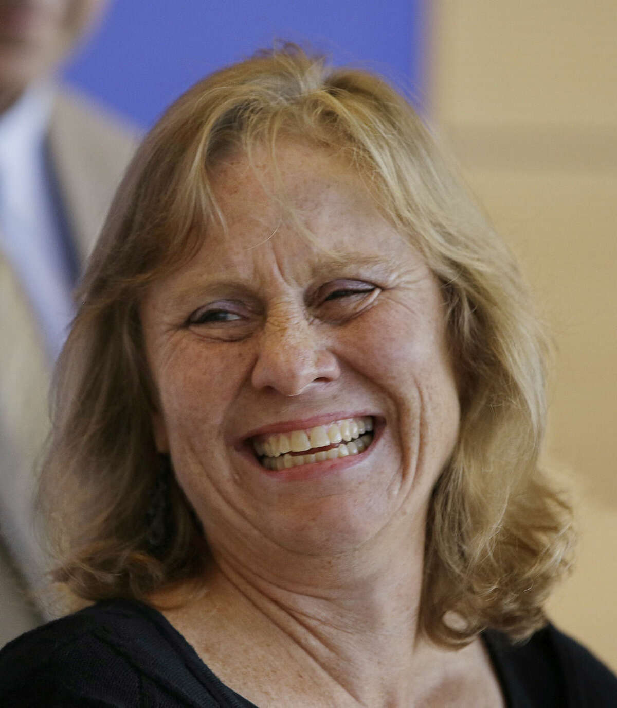 Debbie Sacra, wife of Dr. Rick Sacra, an American doctor who contracted the Ebola virus in Africa, smiles as she announces she spoke to the doctor who put her husband on a plane in Africa bound for the United States during a news conference at the University of Massachusetts Medical School Thursday Sept. 4, 2014 in Worcester, Mass. (AP Photo/Stephan Savoia)