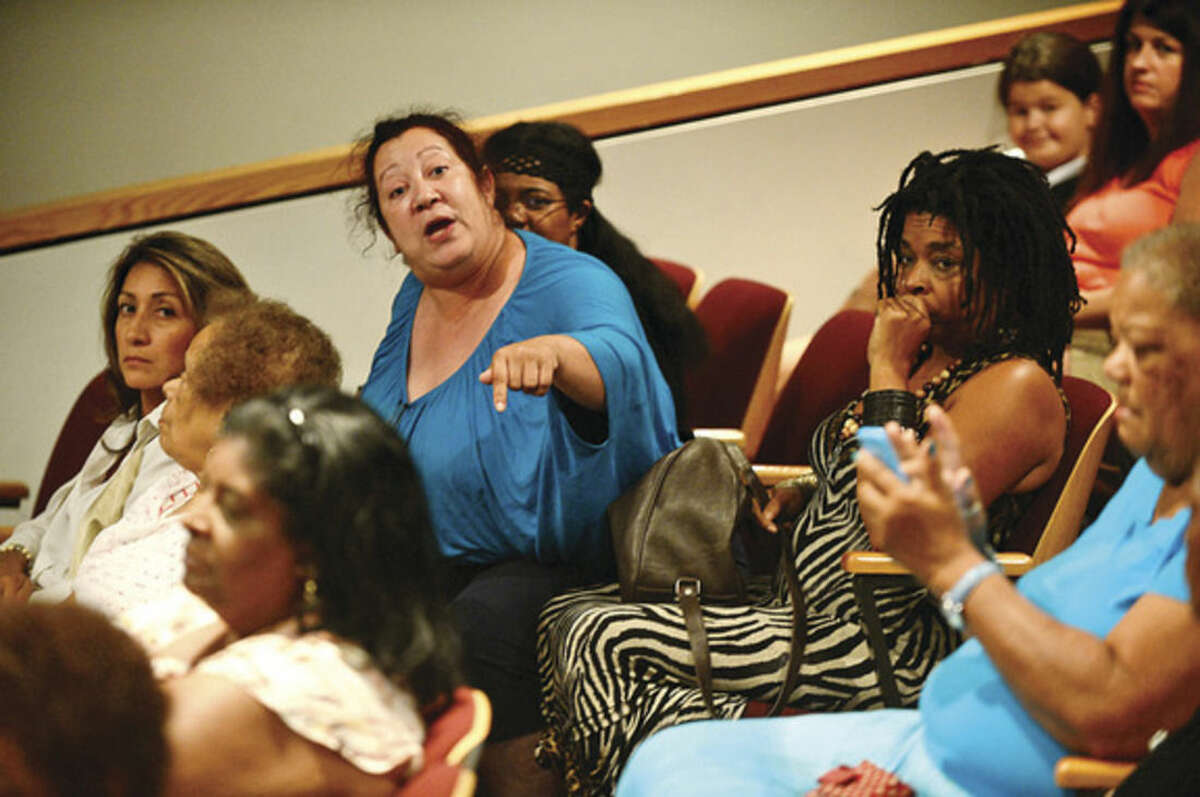 Hour photo / Erik Trautmann Norwalk Board of Education member Migdalia Rivas comments as The Norwalk Branch NAACP sponsors a Town Hall Meeting at City Hall Thursday night to discuss views and concerns regarding recent national incidents including the shooting death of Michael Brown in Ferguson.