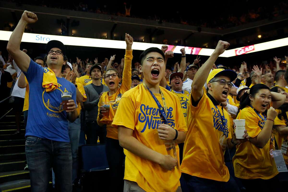 Rossten Nakamura, 16, center, cheers with his family, Stacy and Rachel, right, while fellow fans James and Brianna Stein cheer behind them at left during the second quarter of Game 5 of the NBA finals between the Warriors and the Cavaliers at the Oracle Arena June 13, 2016 in Oakland, Calif.