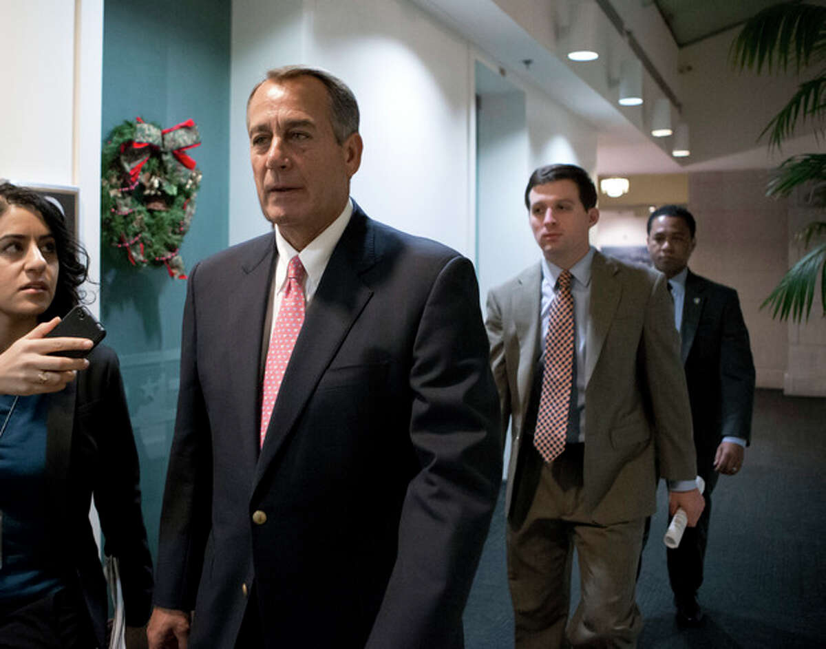 Speaker of the House John Boehner, R-Ohio, walks to a closed-door GOP caucus as Congress meets to negotiate a legislative path to avoid the so-called "fiscal cliff" of automatic tax increases and deep spending cuts that could kick in Jan. 1., at the Capitol in Washington, Sunday, Dec. 30, 2012. (AP Photo/J. Scott Applewhite)