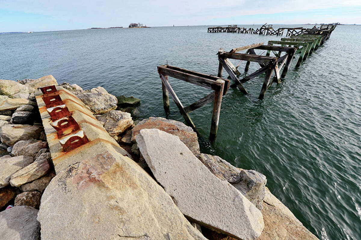Damage from Hurricane Sandy is still apparent at Calf Pasture Beach Tuesday where the remains of Captain William Clarke Pier stand. Hour photo / Erik Trautmann