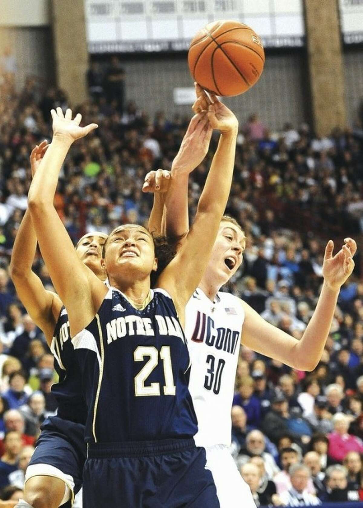 AP photo Notre Dame's Kayla McBride (21) and Skylar Diggins, back left, fight for possession of the ball against UConn's Breanna Stewart during the second half of Saturday's game at Gampel Pavilion. McBride and Diggins were top scorers for the fifth-ranked Irish with 21 and 19 points, respectively, in their 73-72 upset of No. 1 UConn.