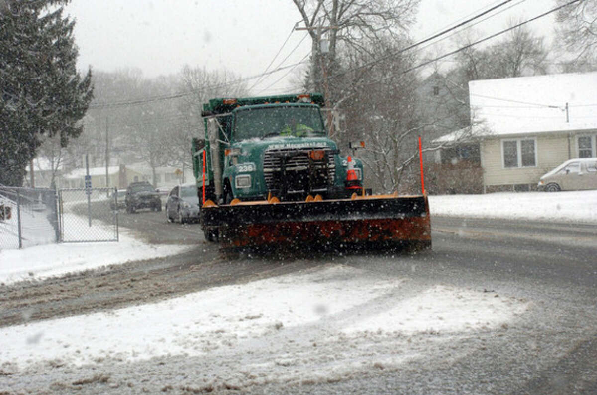 City workers plow Ward Street in Norwalk Wednesday afternoon during the snow storm. Hour Photo / DANIELLE ROBINSON