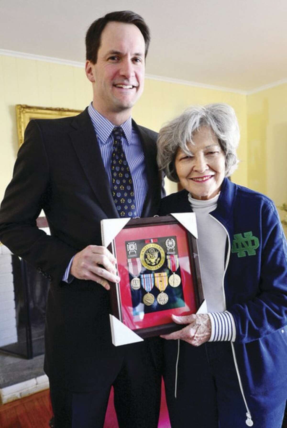 US Congressman Jim Himes delivers eight military service medals to the widow of late U.S. Army Sgt. Clarence Schaffer Jr., Kathleen Schaffer, recognizing the World War II veteran's service as a member of the Parachute Infantry Regiment during a brief ceremony at the Schaffer home Tuesday morning.