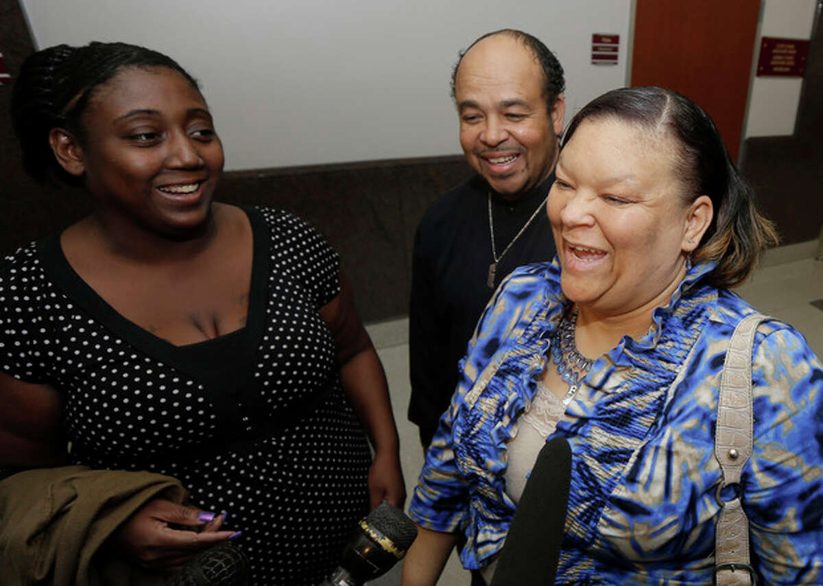 Auboni Champion-Morin, left, laughs with Juanita, right, and Joesph Aguillard after a court hearing regarding Champion-Morin's son Wednesday, Jan. 9, 2013, in Houston. A judge in Houston ruled Wednesday that 8-year-old Miguel Morin, a Texas boy who was kidnapped as a baby, should be removed from foster care and given to the Aguillard's, who are caring for his four siblings. The boy has been in foster care since authorities found him in March living in East Texas with his former baby sitter. The boy's former baby sitter and her mother are charged with kidnapping.(AP Photo/David J. Phillip)
