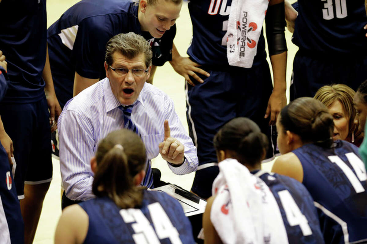Connecticut head coach Geno Auriemma talks to his team during a timeout in the first half of an NCAA college basketball game against Georgetown, Wednesday, Jan. 9, 2013, in Washington. (AP Photo/Alex Brandon)