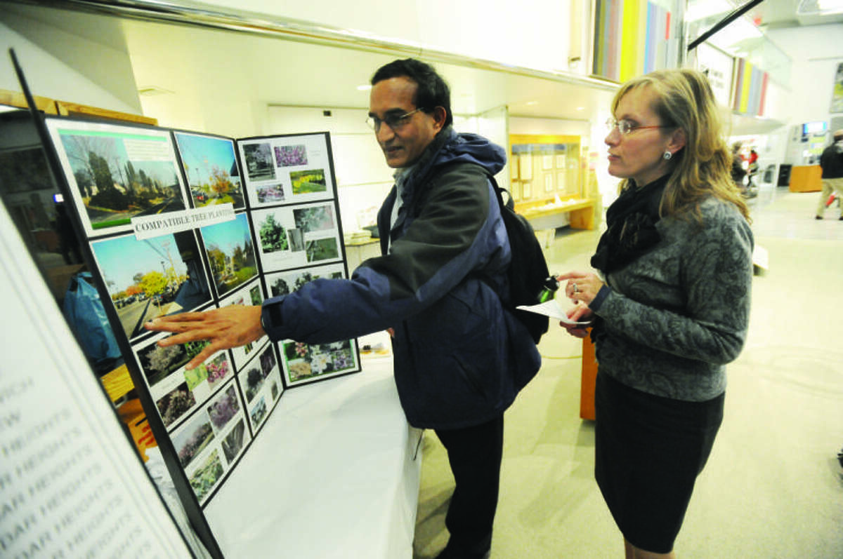 Katie Blint with CL&P communications speaks with Veera Karukonda about trees and utilities lines Tuesday. CL&P hosted an open house for residents at the Government Center in Stamford. 