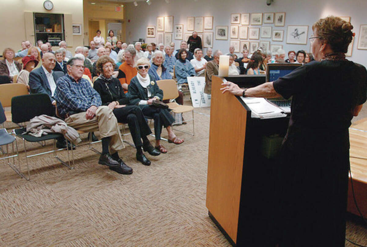 Estelle Margolis, wife of the late activist Manny Margolis, addresses the crowd at the Westport Public Library that turned out to honor Margolis who died in August.