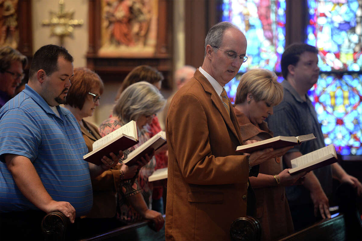Attendants of Monday's mass at the St Anthony Cathedral Basilica sing from the hymn books on Monday. A special dedication was given during the mass for the victims of last weekend's mass shooting in Orlando. Photo taken Monday, June 13, 2016 Guiseppe Barranco/The Enterprise