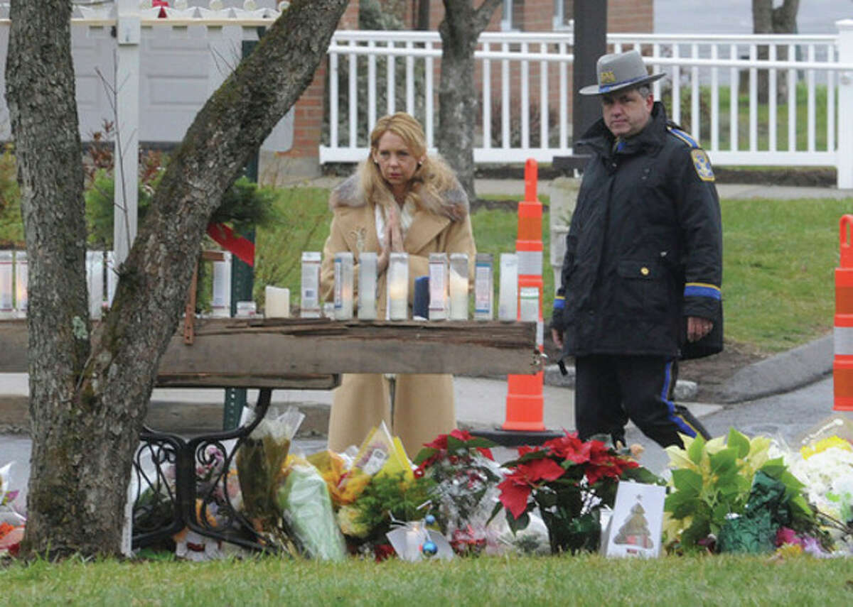 A mourners pays respects Sunday at Saint Rose of Lima church in Newtown, one of the many services for the victims of Sandy Hook Elementary school. hour photo/Matthew Vinci