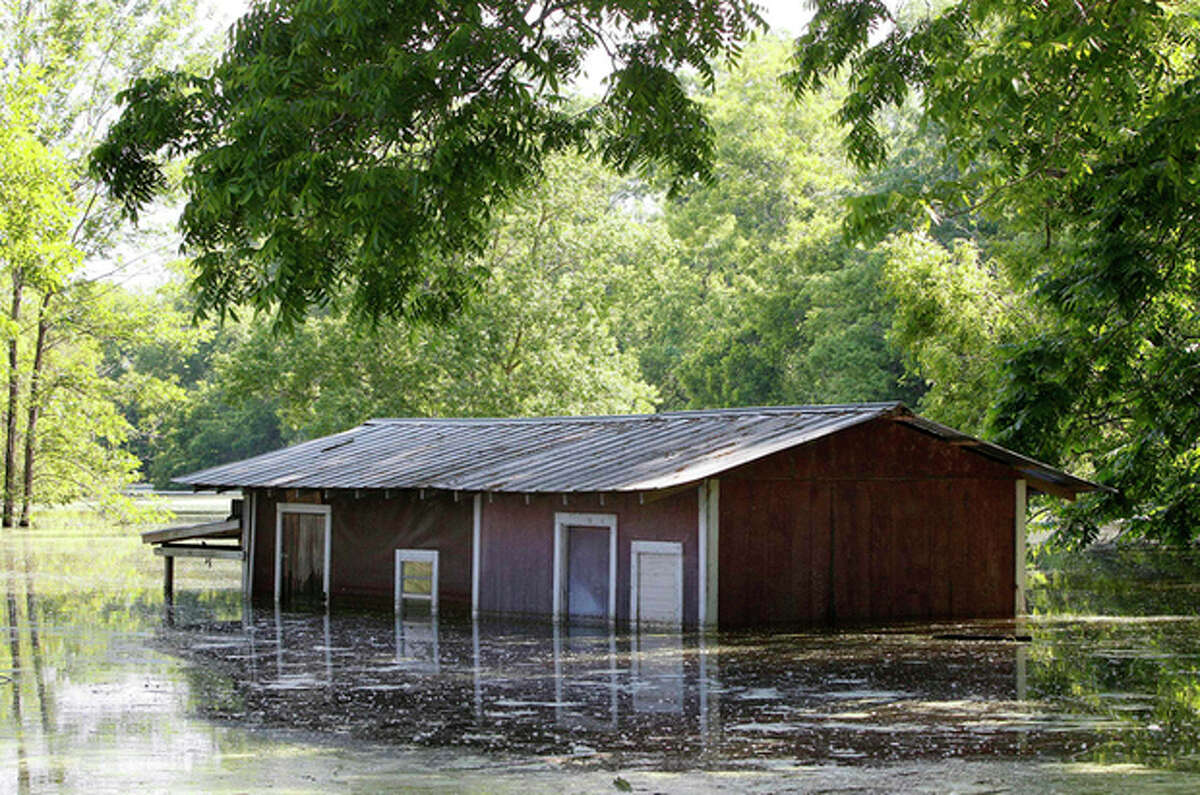 FILE - This May 18, 2011 file photo shows a partially-flooded building on the banks of the Atchafalaya River outside of the levee protection area in Simmesport, La. Inspectors taking the first-ever inventory of flood control systems overseen by the federal government have found hundreds of structures at risk of failing and endangering people and property in 35 states. Levees deemed in unacceptable condition span the breadth of America. They are in every region, in cities and towns big and small. (AP Photo/Patrick Semansky, File)