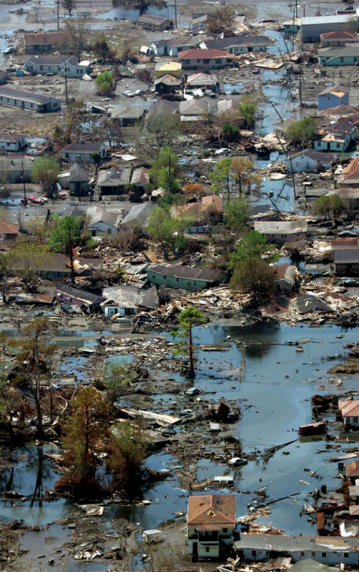 FILE - This Sept. 11, 2005 file photo shows a neighborhood destroyed by Hurricane Katrina in New Orleans. Inspectors taking the first-ever inventory of flood control systems overseen by the federal government have found hundreds of structures at risk of failing and endangering people and property in 35 states. Levees deemed in unacceptable condition span the breadth of America. They are in every region, in cities and towns big and small. (AP Photo/David J. Phillip, File)