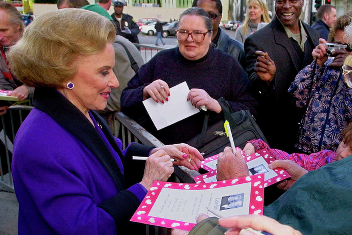 FILE - In this Feb. 14, 2001 file photo, "Dear Abby" advice columnist Pauline Friedman Phillips, 82, known to millions of readers as Abigail van Buren, signs autographs for some of dozens of fans after the dedication of a "Dear Abby" star on the Hollywood Walk of Fame in Los Angeles. Phillips, who had Alzheimer?’s disease, died Wednesday, Jan. 16, 2013, she was 94. Phillips' column competed for decades with the advice column of Ann Landers, written by her twin sister, Esther Friedman Lederer. Their relationship was stormy in their early adult years, but later they regained the close relationship they had growing up in Sioux City, Iowa. The two columns differed in style. Ann Landers responded to questioners with homey, detailed advice. Abby's replies were often flippant one-liners. (AP Photo/Reed Saxon)