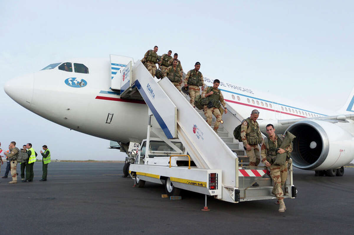 In this picture dated Sunday, Jan. 13, 2013 and released by the French Army Communications Audiovisual office (ECPAD) French soldiers of the 21st Marine Infantry Regiment based in Frejus, southern France, exit a plane at Bamako airport, Mali. An official at France's Defense Ministry says the country will "gradually deploy" a total of 2,500 troops to Mali, and the French president says the military operation will last until security has been restored and African forces are ready to take charge. (AP Photo/Jeremy Lempin, ECPAD)